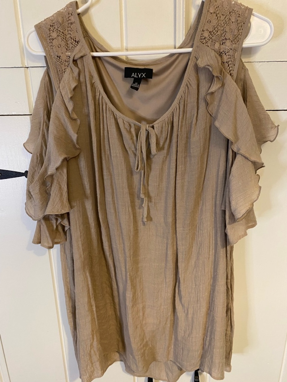 Alyx Taupe Ruffled Cold Shoulder Gauzy Tunic with Tie Neckline & Lace Trim. 1X.